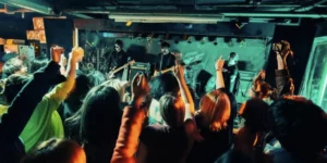 Indie artists influencing K-pop sounds performing at an underground venue with an energetic audience in Seoul's live music scene