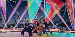 K-pop Evolution displayed through dynamic group choreography on futuristic stage with vibrant visual production showcasing next-generation performance technology