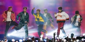 K-pop concert evolution showcased through dynamic BTS stadium performance with synchronized choreography and illuminated light sticks creating an immersive fan experience