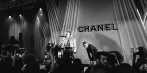 K-pop's relationship with luxury brands exemplified at Chanel event performance with fashionable stage design and engaged audience