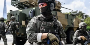 Korean military service soldier in advanced combat gear and digital camouflage uniform during tactical training exercise
