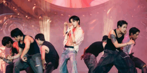 J-Hope Lollapalooza Berlin performance on stage with backup dancers in pink lighting