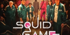 Squid Game Netflix global charts cast featuring player 456 Gi-hun and contestants in green tracksuits with pink guards
